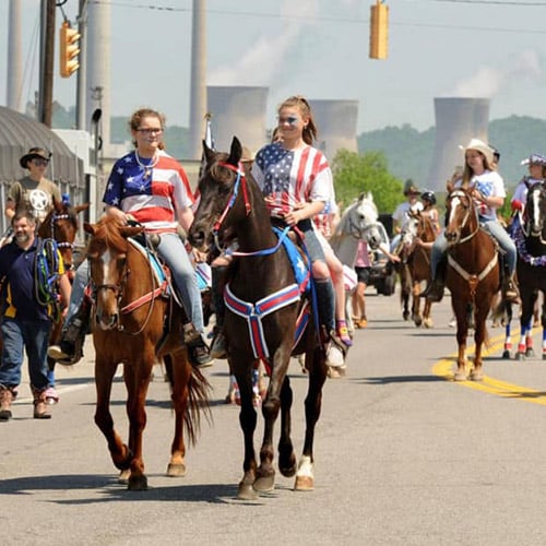 Group of girls horseback riding in a parade